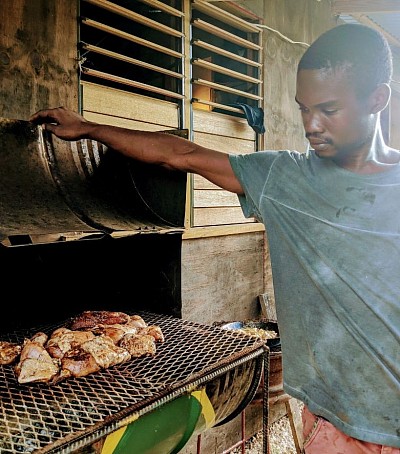 Farmhouse cook Penny grilling some jerk chicken