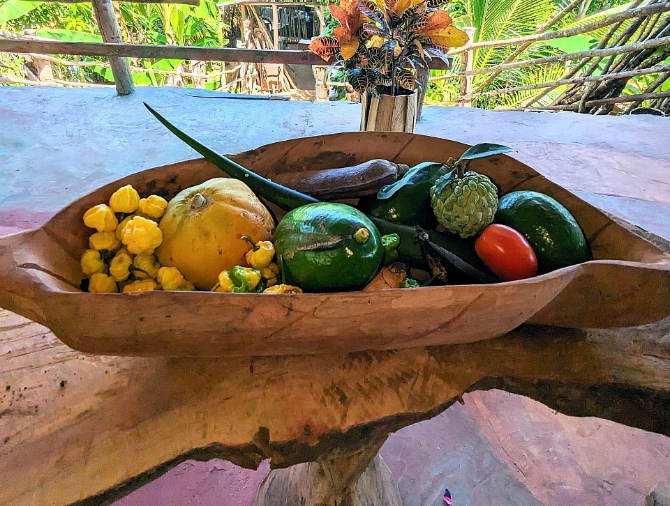 An ever changing array of fresh tropical produce in a hand-carved bowl & table made from guango